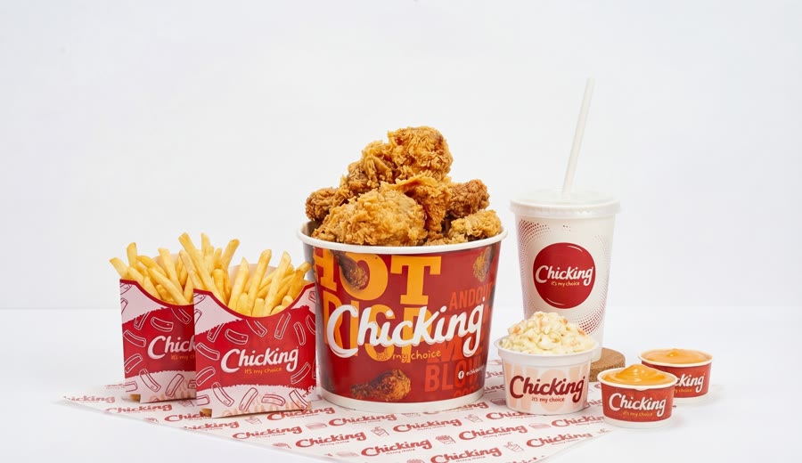 A Chicking bucket meal with fries, drink and sides