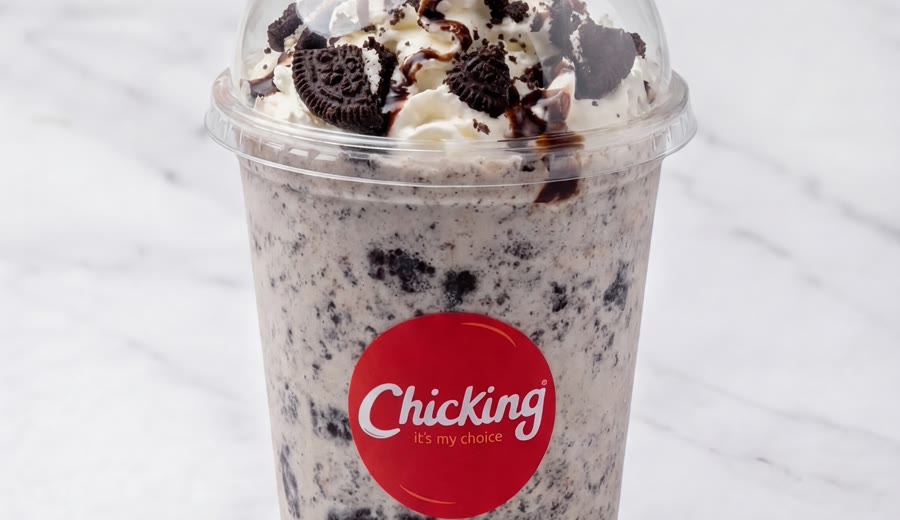 An Oreo milkshake topped with cream and cookies